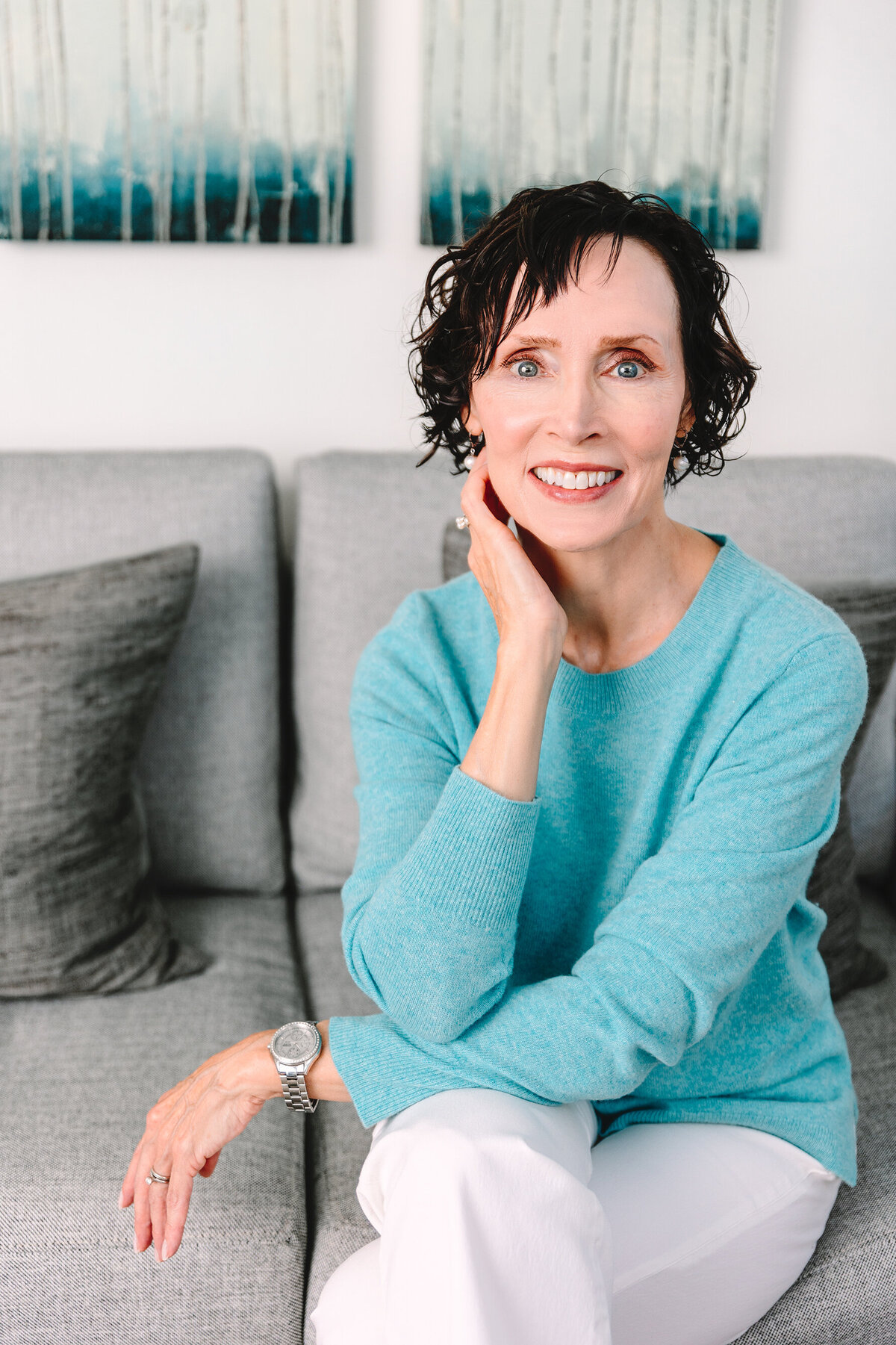 Casual headshot of psychologist sitting on couch