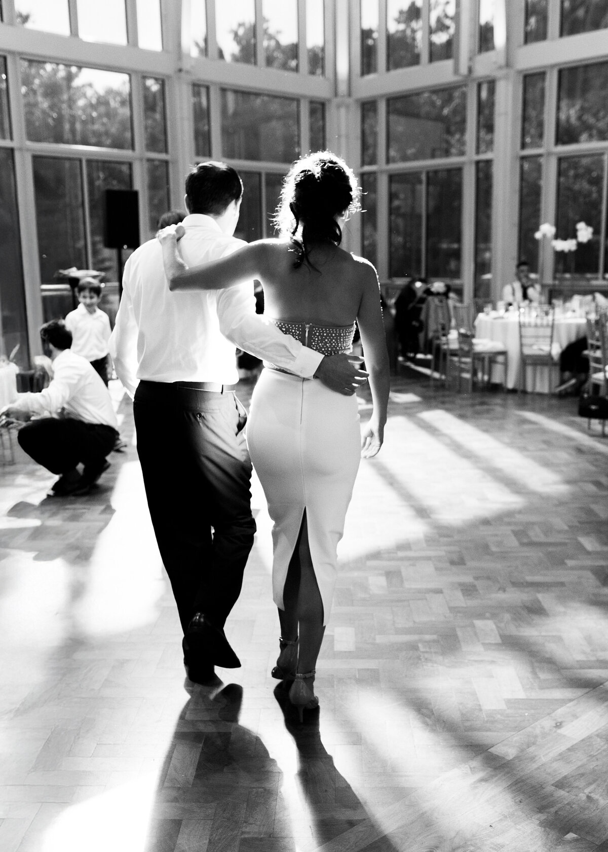 Couple enter dance floor at a formal birthday gala.