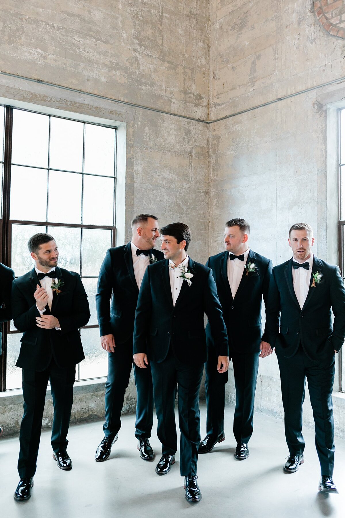 Groomsmen walking in the chapel at Olde Dobbin Station.