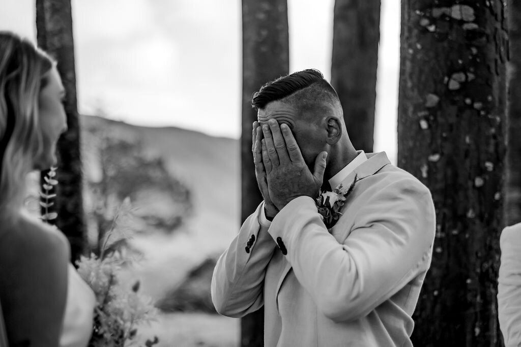 Logans first reaction to seeing Kayleigh at the aisle a moment during their forest wedding in Auckland, photographed by Zanthe Vorsatz Photography.