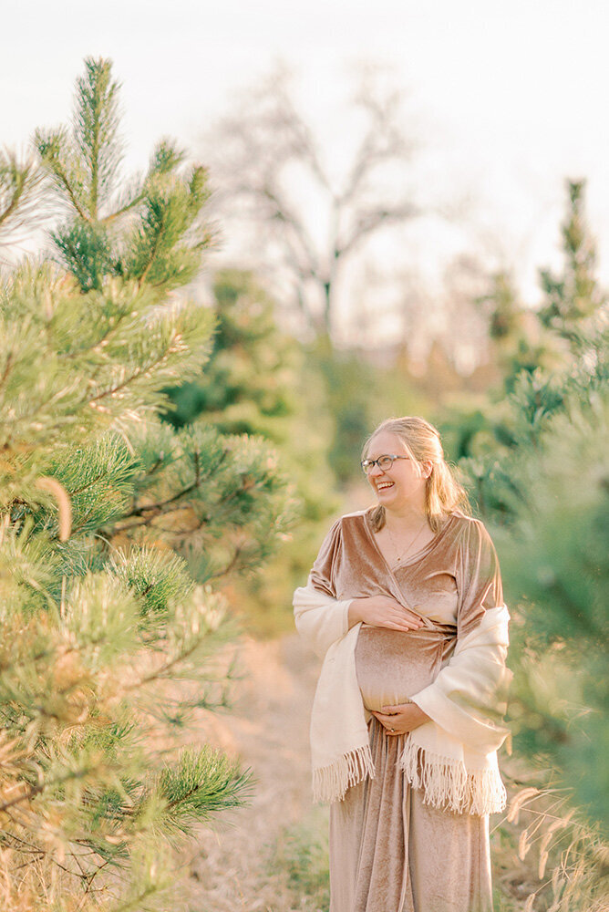 Woman holding her baby bump and laughing