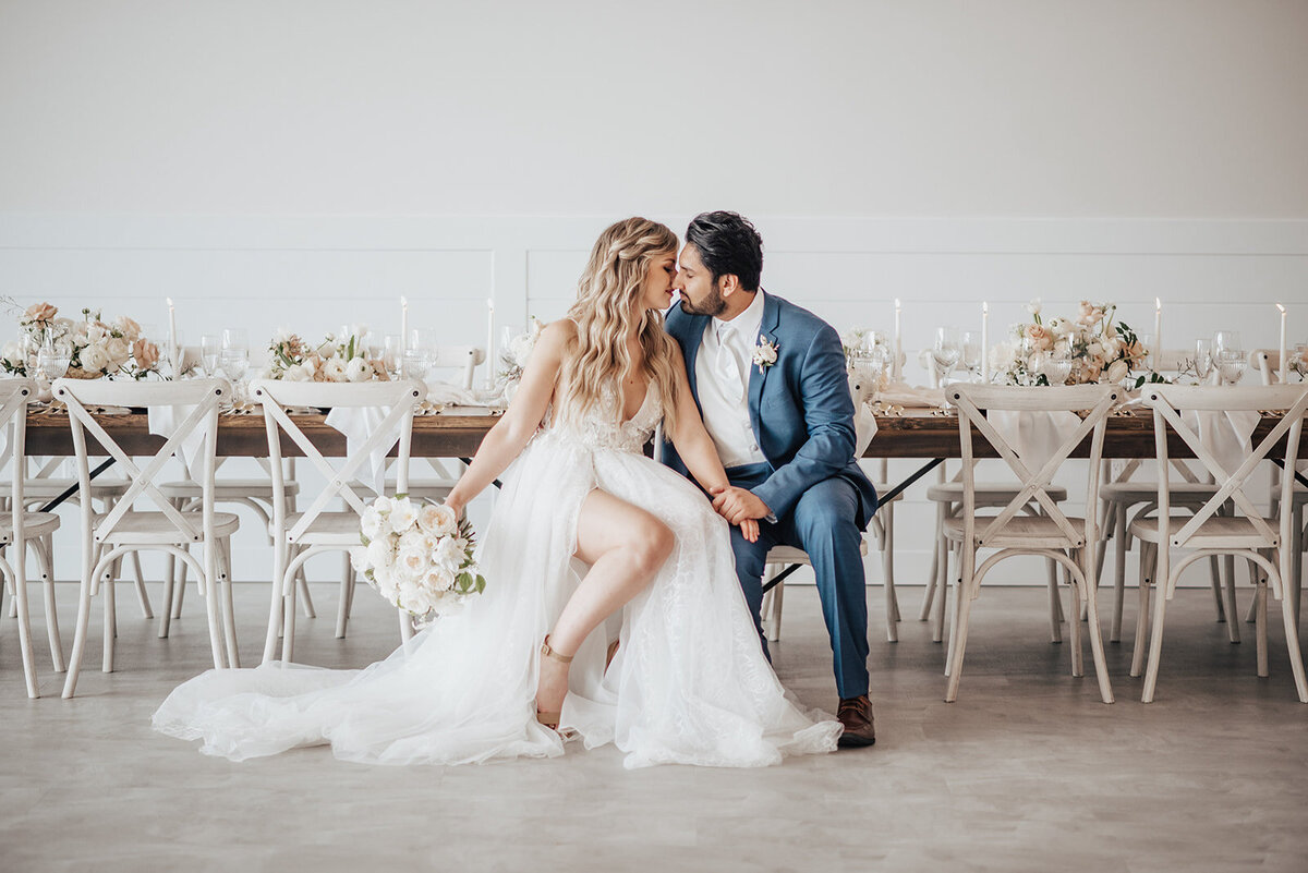 Couple at their indoor reception at Tin Roof Event Centre, a modern wedding venue in Lacombe, Alberta, featured on the Brontë Bride Vendor Guide.