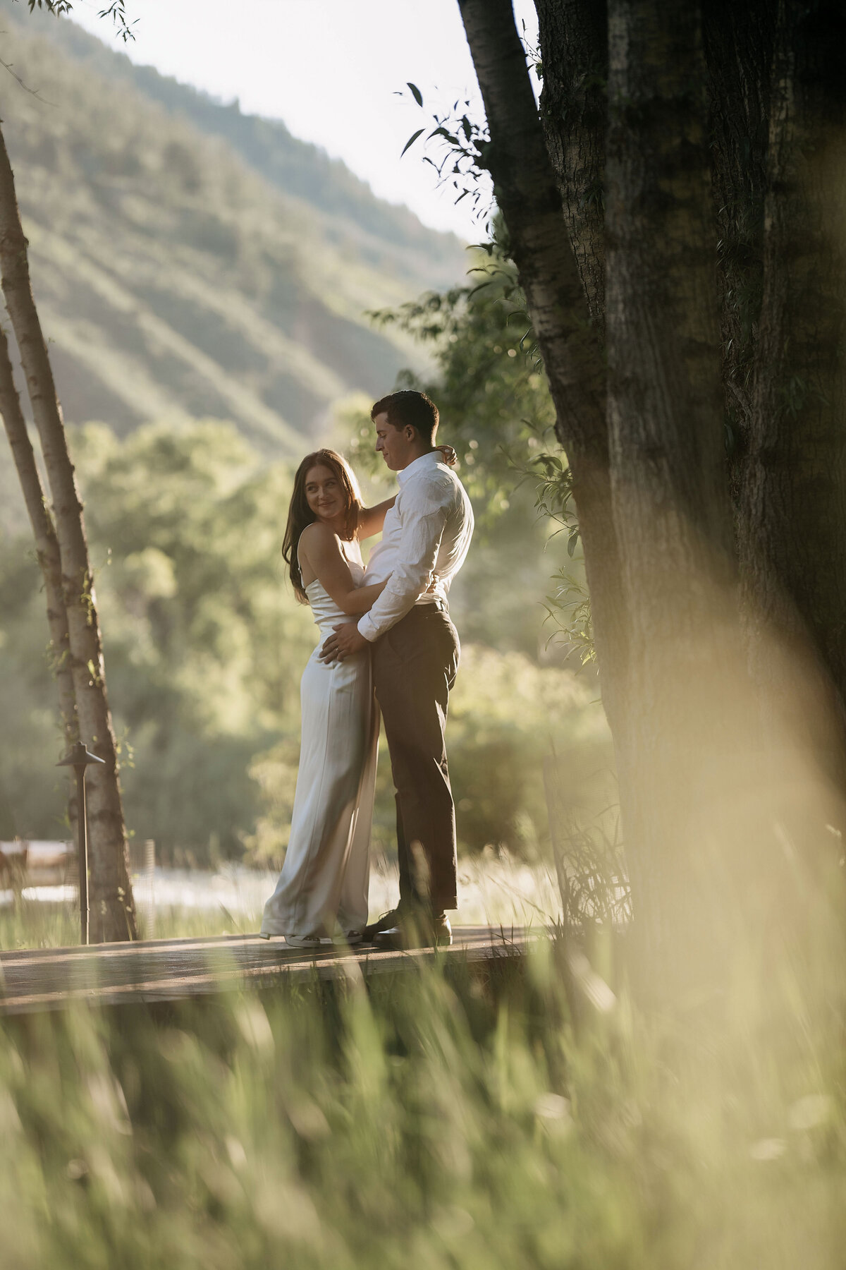 Golden hour photos with the bride and groom, as the sun caught the green grass they pose for a photo,