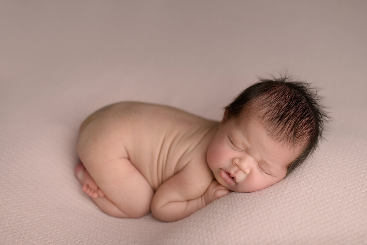 Sleeping newborn on belly