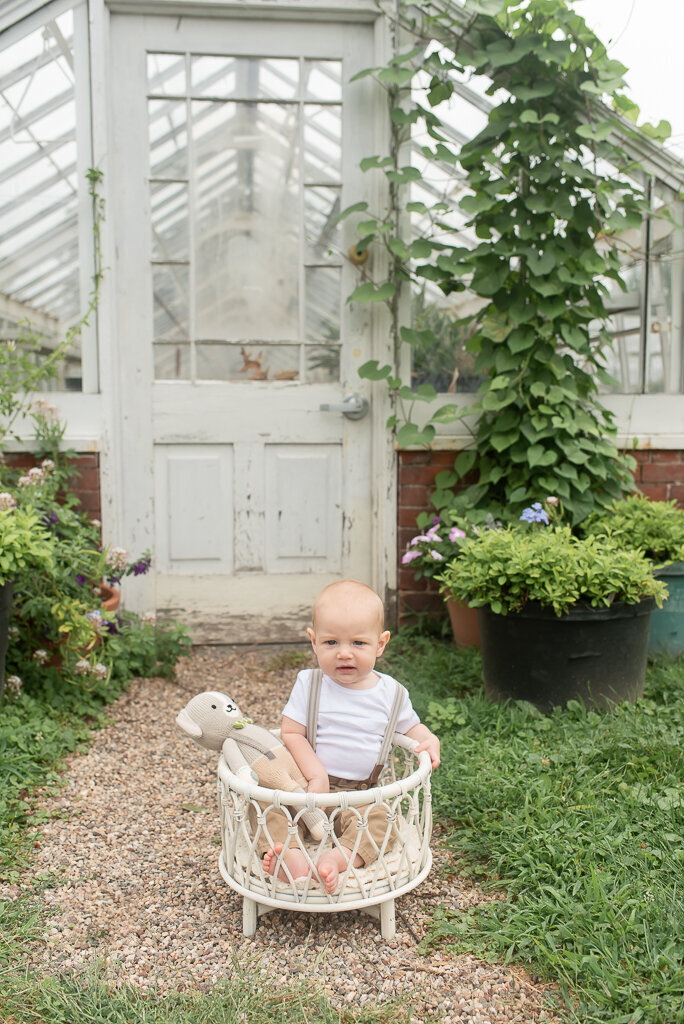 Little boy in crib in front of greenhouse door at Elizabeth Park, West Hartford, C |Sharon Leger Photography | Canton, CT Newborn & Family Photographer