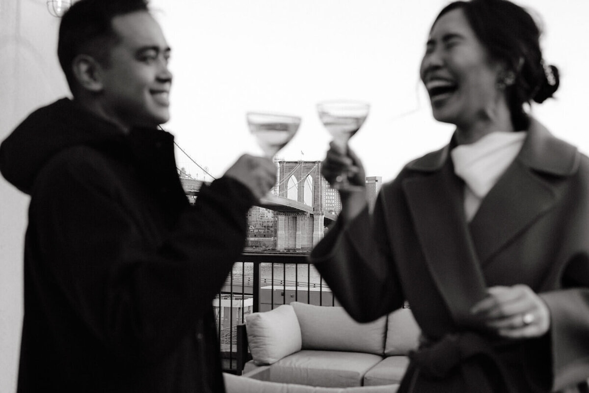 The bride and the groom are laughing while having their first champagne toast.