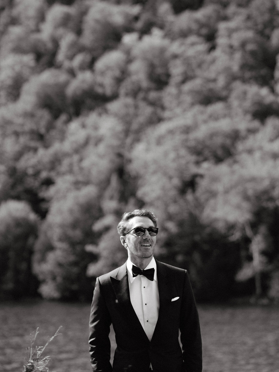 adirondack-mountain-wedding-08-groom-in-a-timeless-tuxedo,-standing-confidently-outdoors-at-adirondack-mountain-wedding-jenny-fu-studio