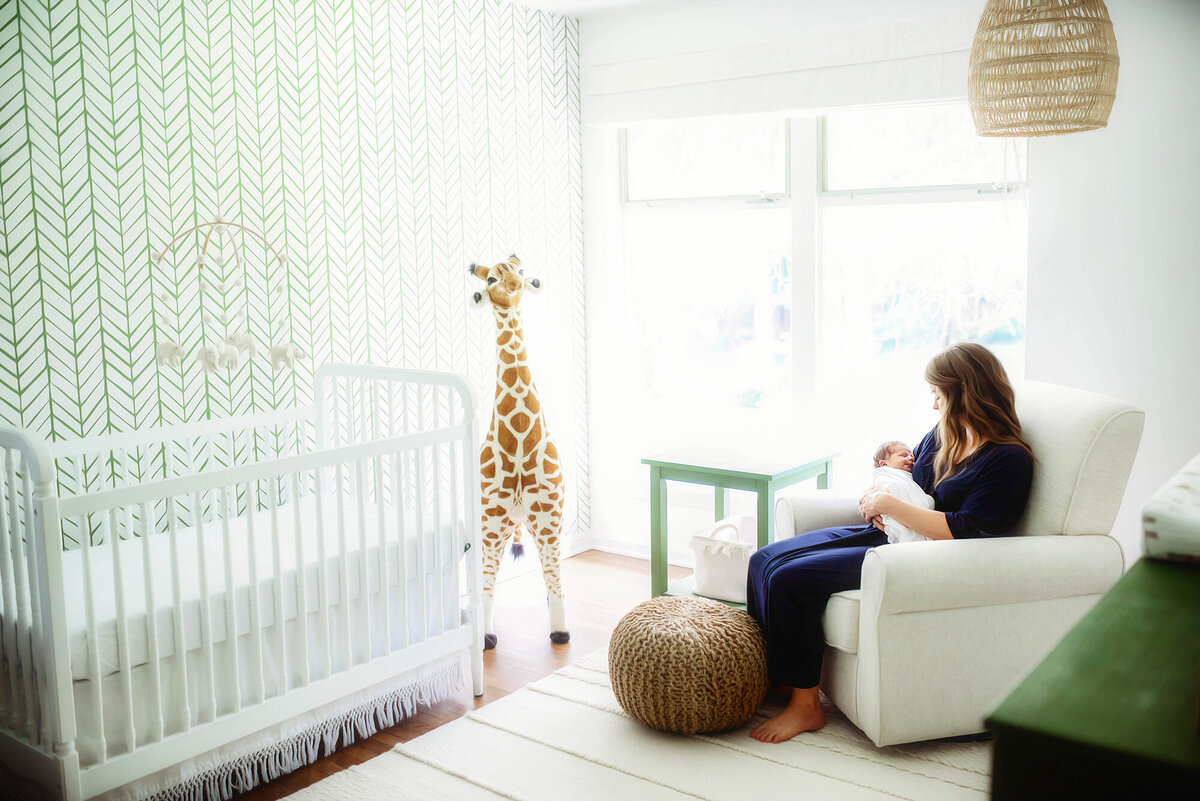 Charleston’s #1 Lifestyle Newborn Photographer, mother holding her infant for Newborn Photoshoot in Charleston, SC.