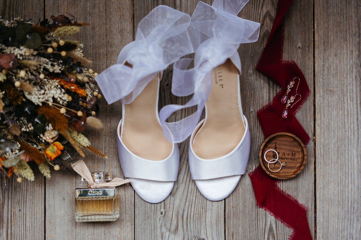 Flatlay with stationery, ribbons, and sentimental Dolomites elopement details