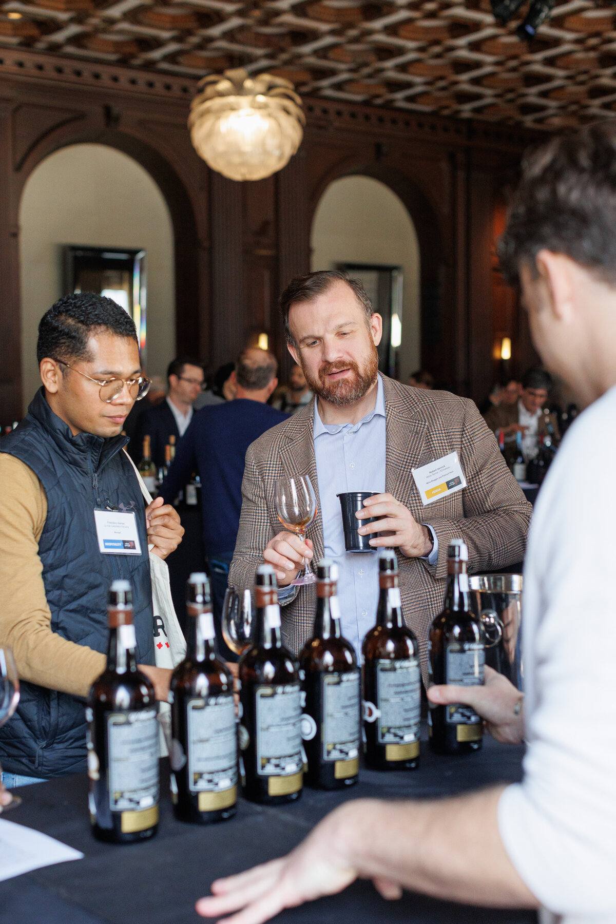 two males looking at bottles of Portugal Wine