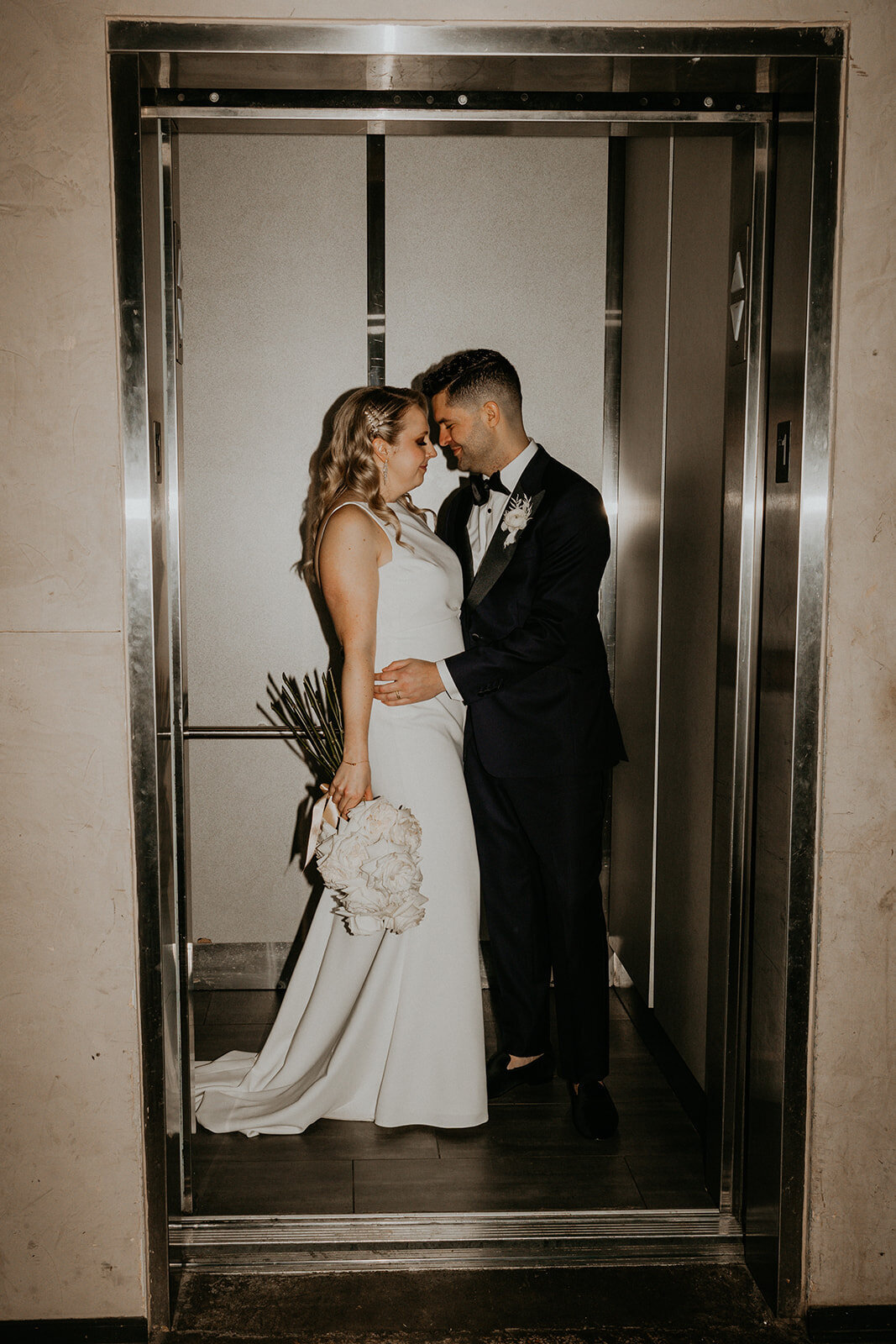 bride and groom in an elevator in downtown Knoxville