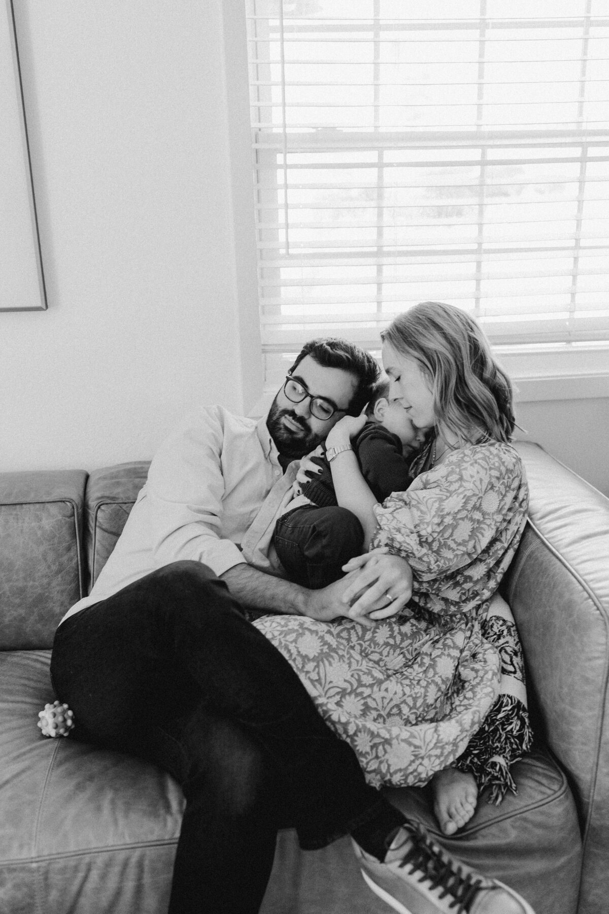 Mother and father snuggling baby at Austin family photo session