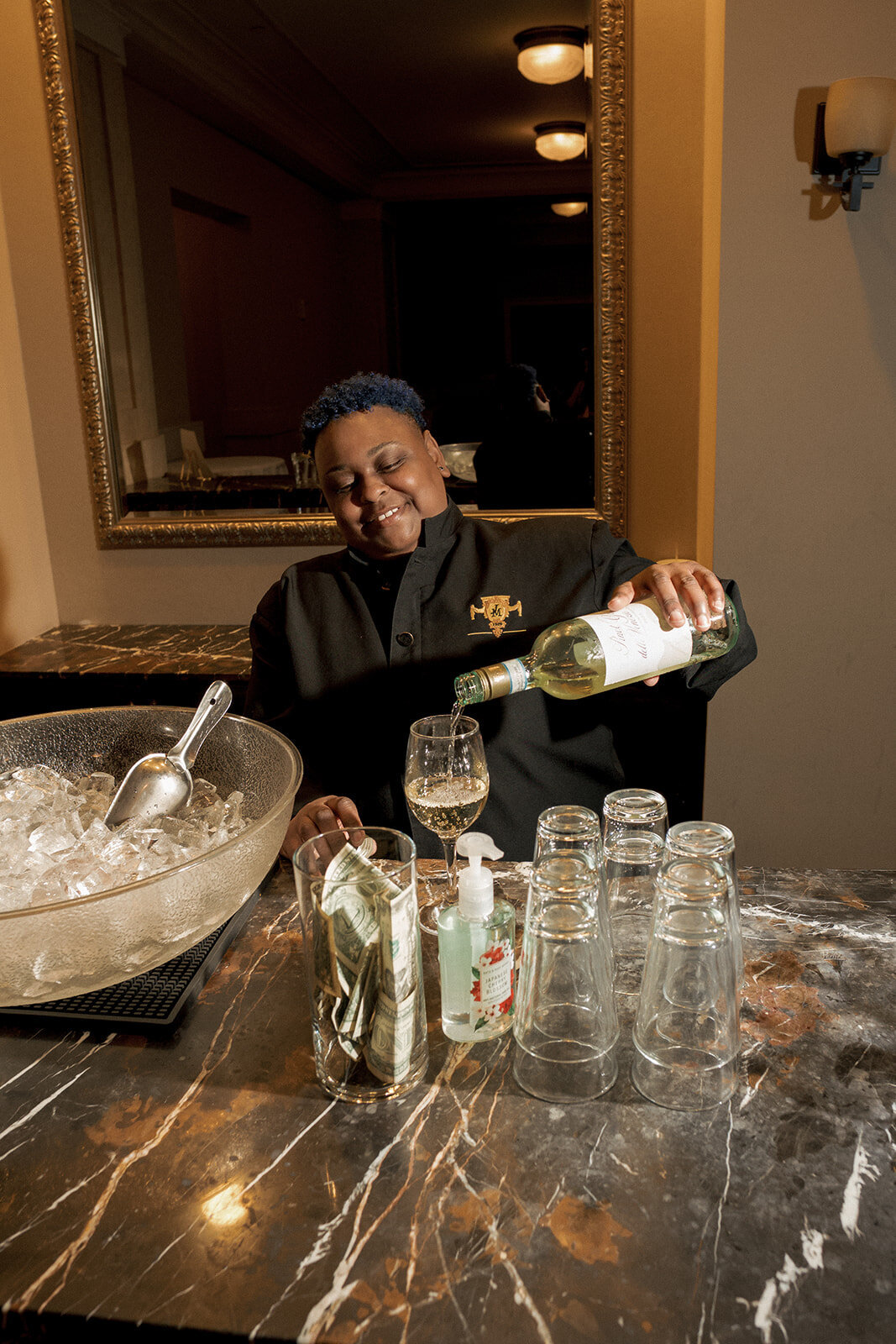 bartender smiling serving wine cocktail hour