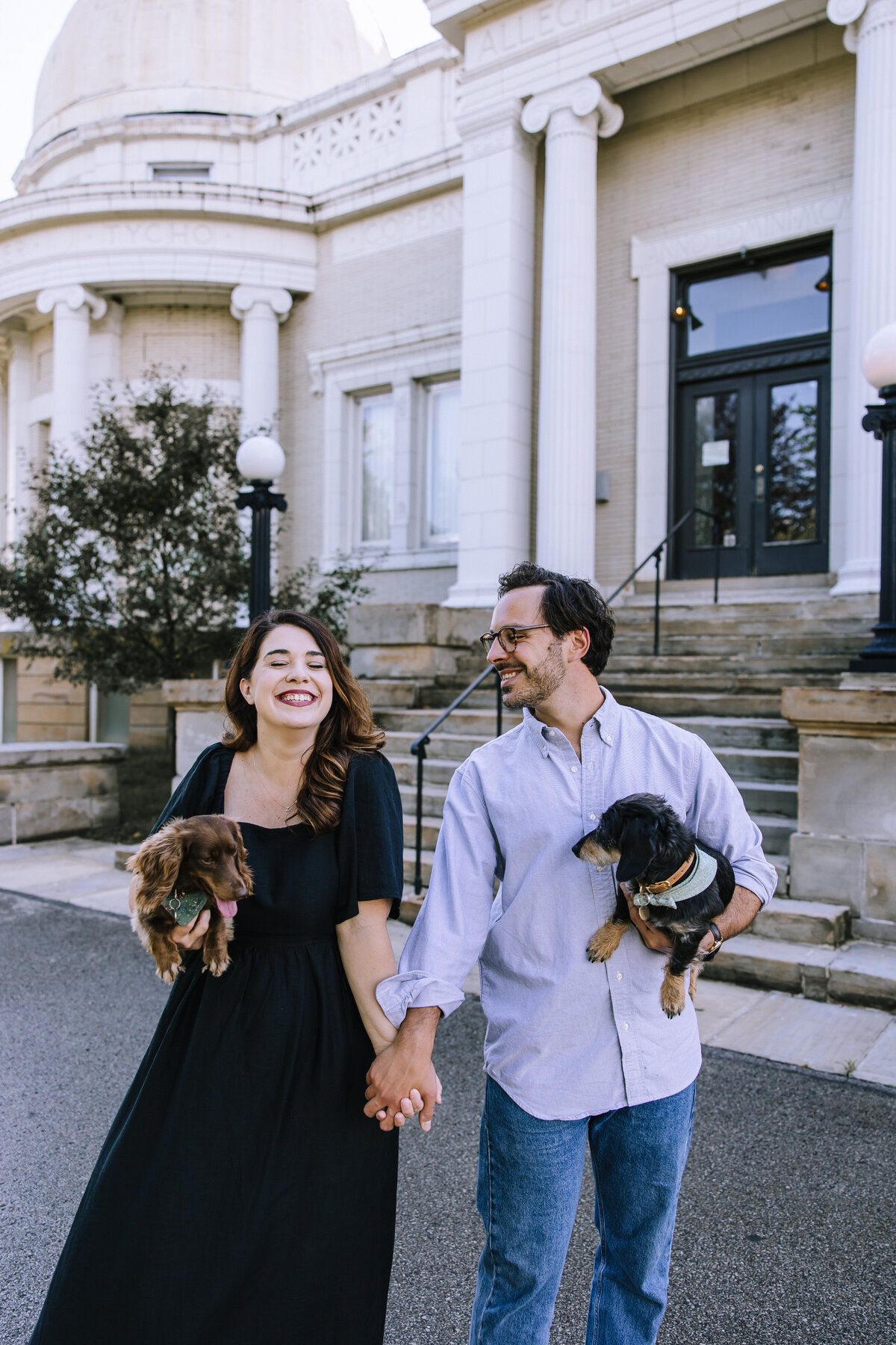 Engaged couple with their wiener dogs. 