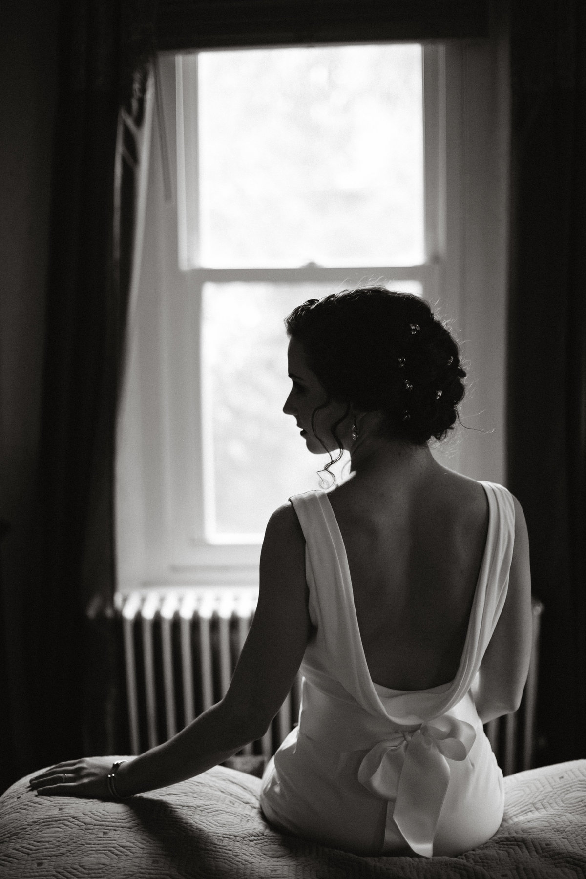 Bride wearing a gorgeous low back wedding gown, photographed by Sweetwater.