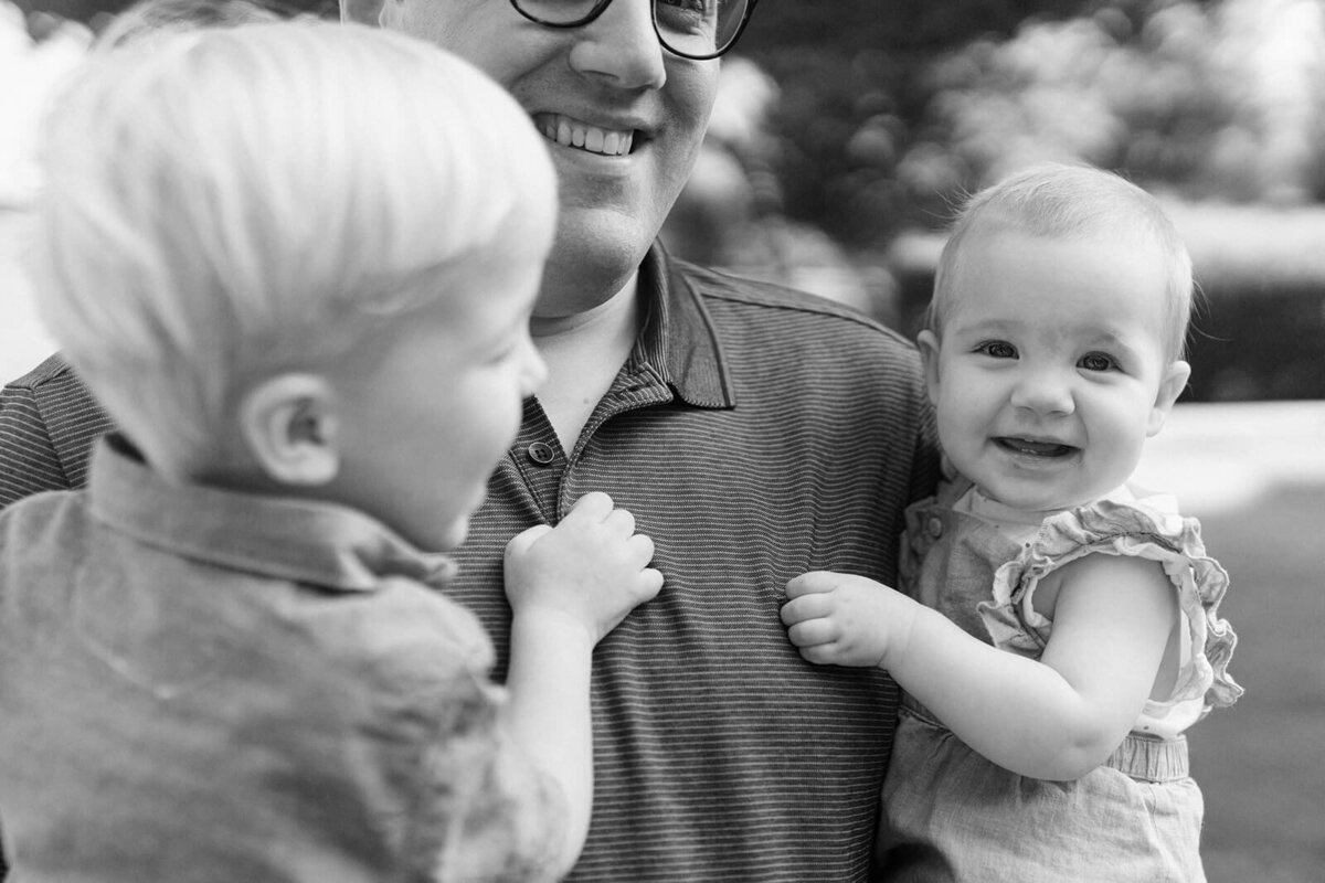 Man holding two young children at generational photoshoot in Finger Lakes, NY