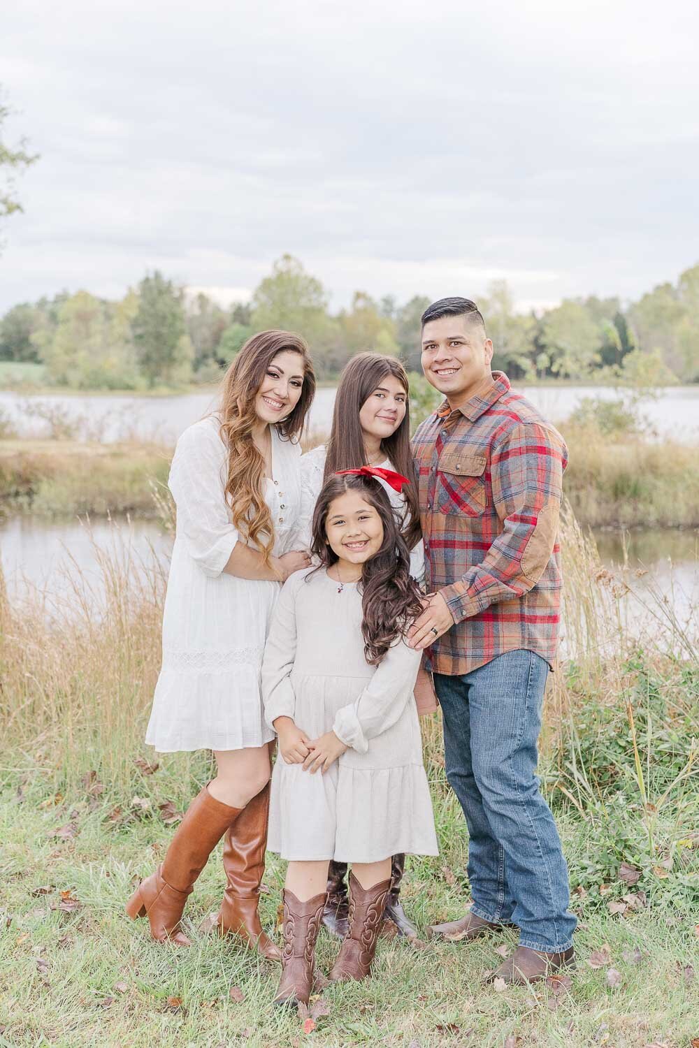 family of 4 posing for photos during fall minis taken by a Manassas, VA photographer