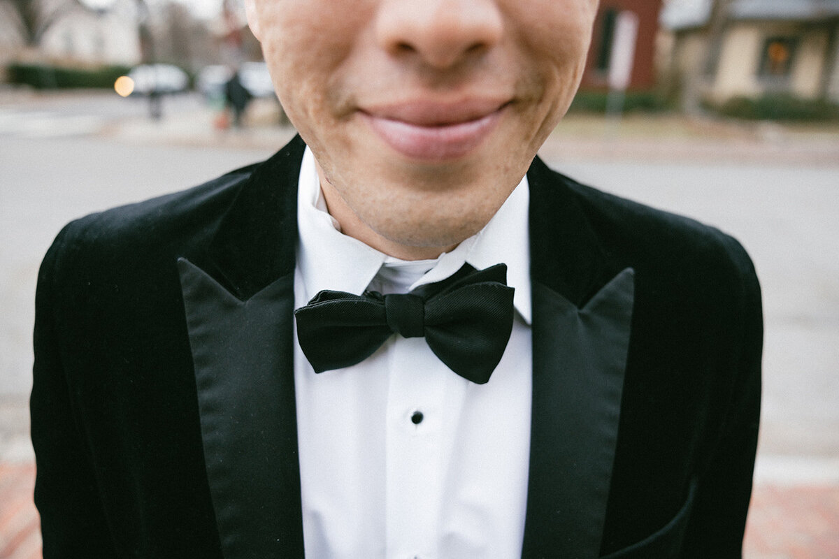 Tie and tux are featured with a grooms relaxed smile on his elopement day. 
