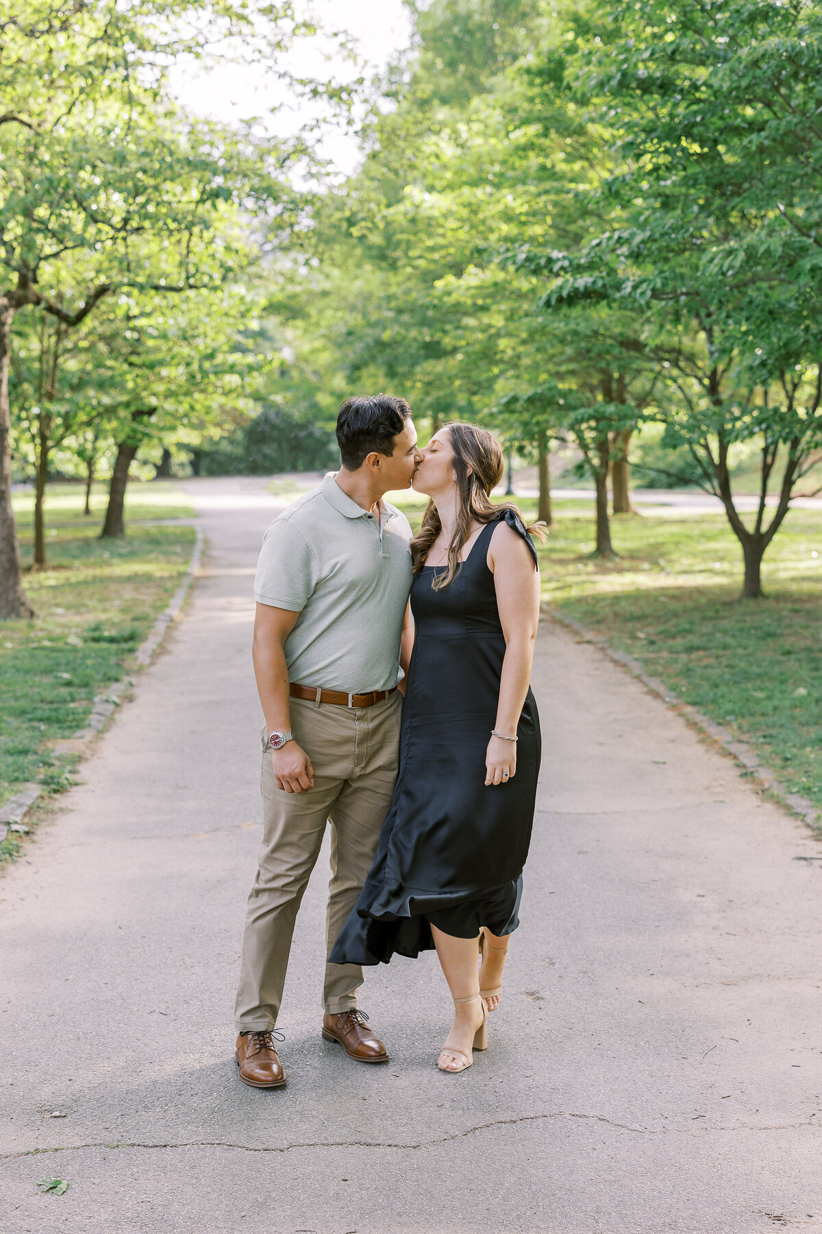 Couple kissing in an Atlanta park for an engagement session