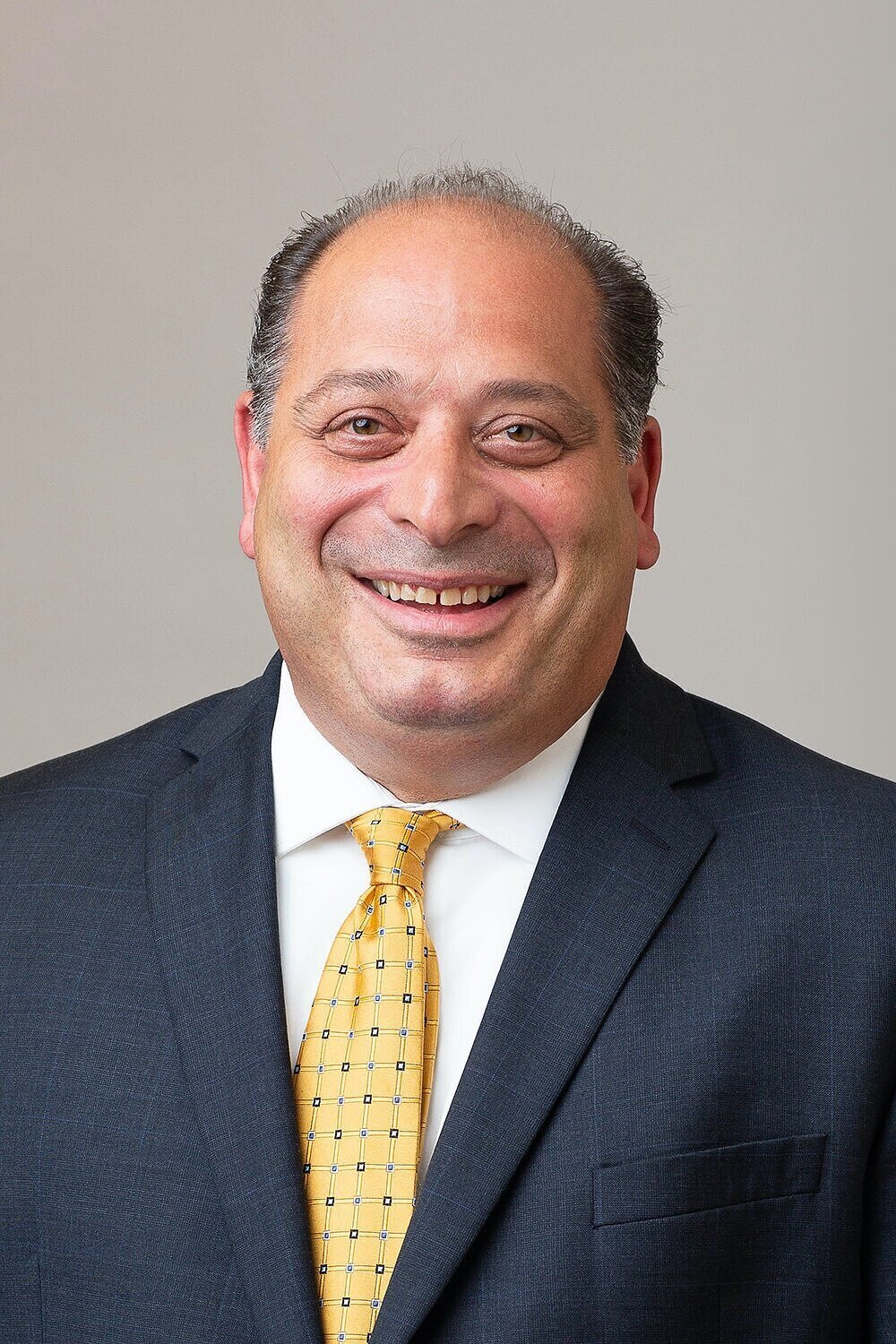 Smiling man in a yellow tie