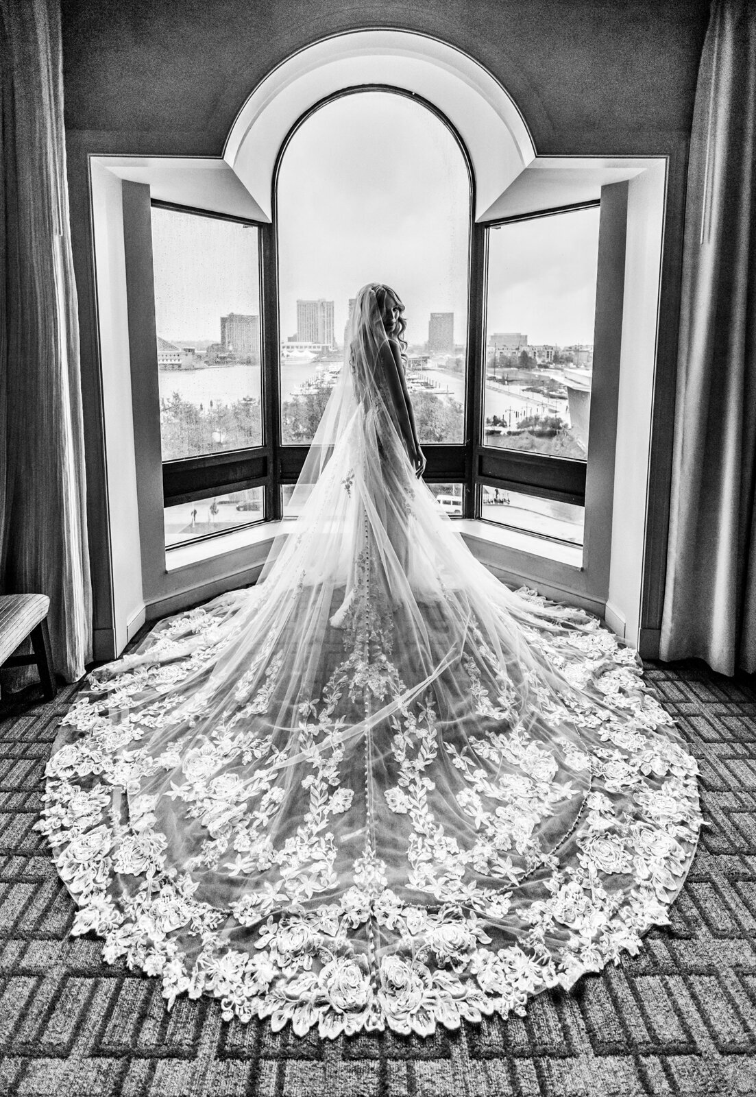 Bride standing in front of windows at the Royal Sonesta Harbor Court