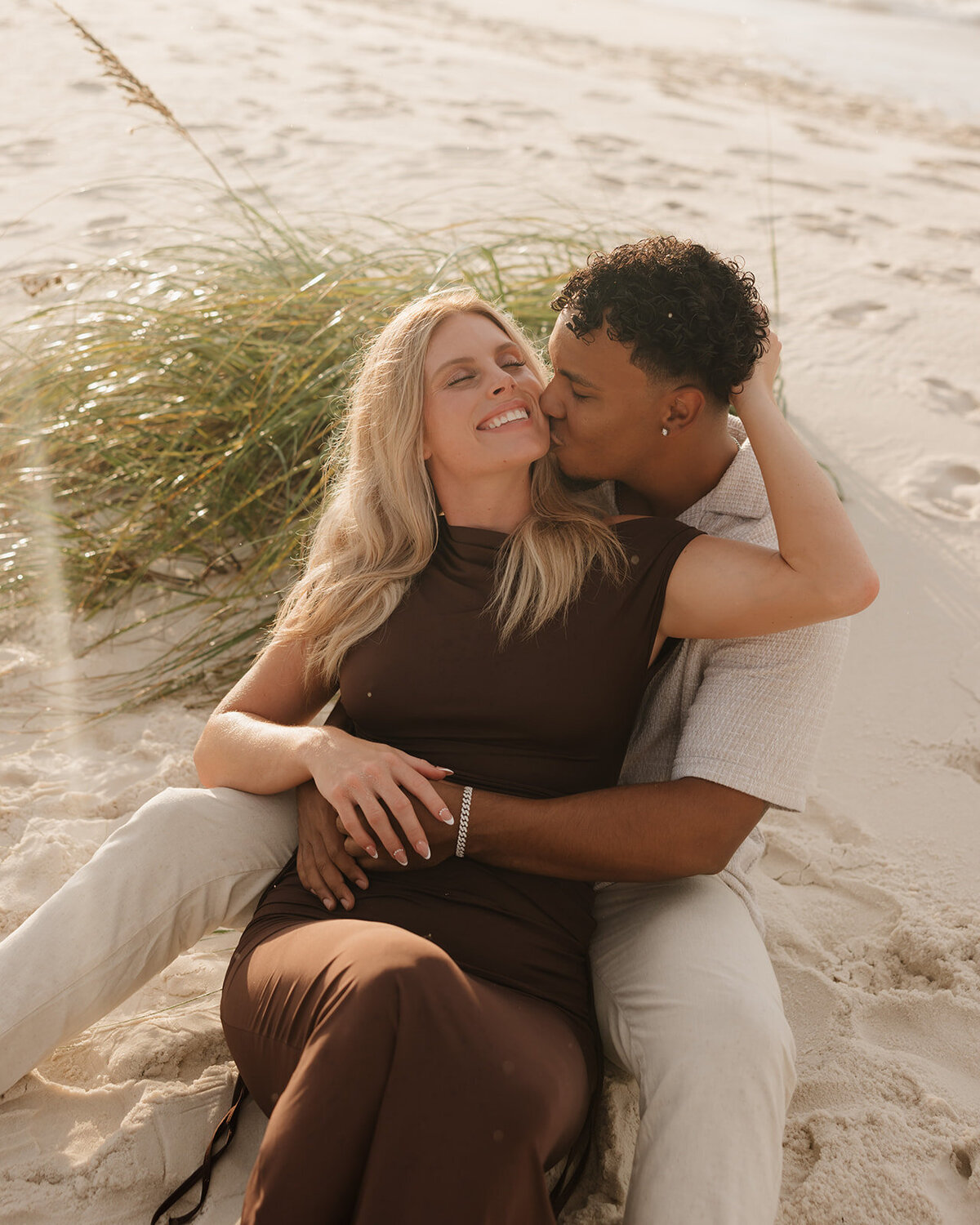 man kisses woman on her cheek