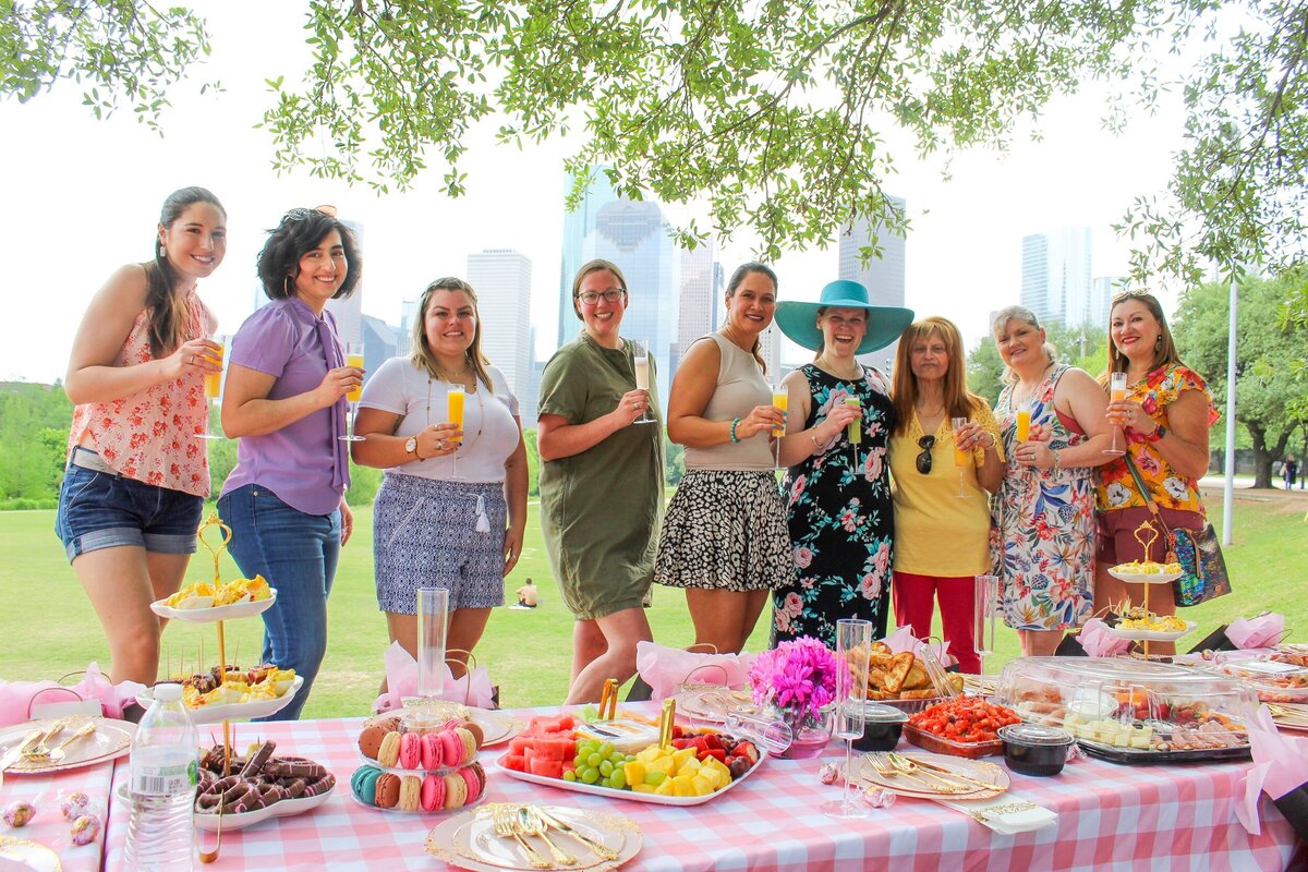 Group holding drinks at picnic