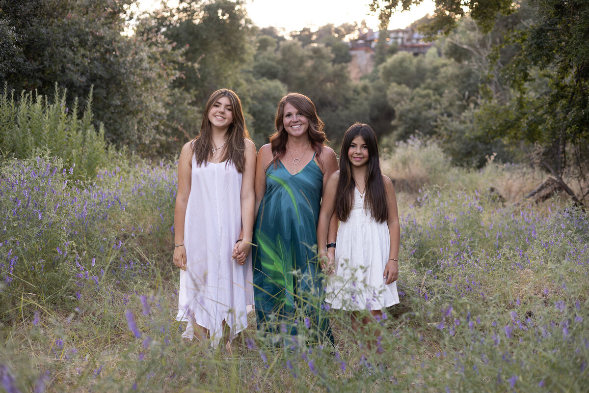 teenage daughters and their mom in wildflowers