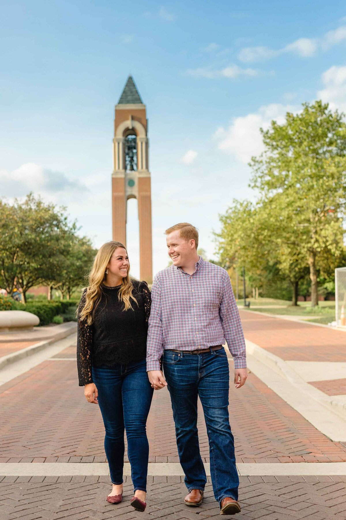 Couple walking in front of bell tower at ball state