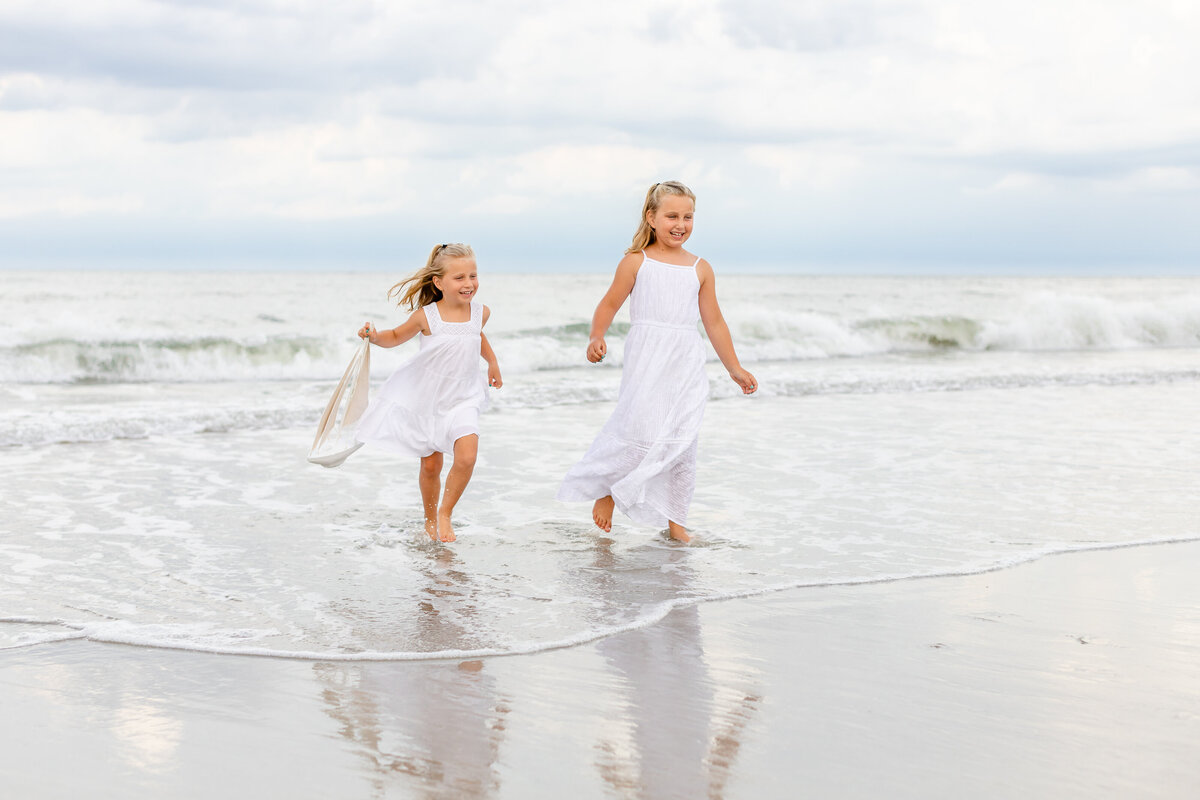Girls playing in the water in Jacksonville during their family session