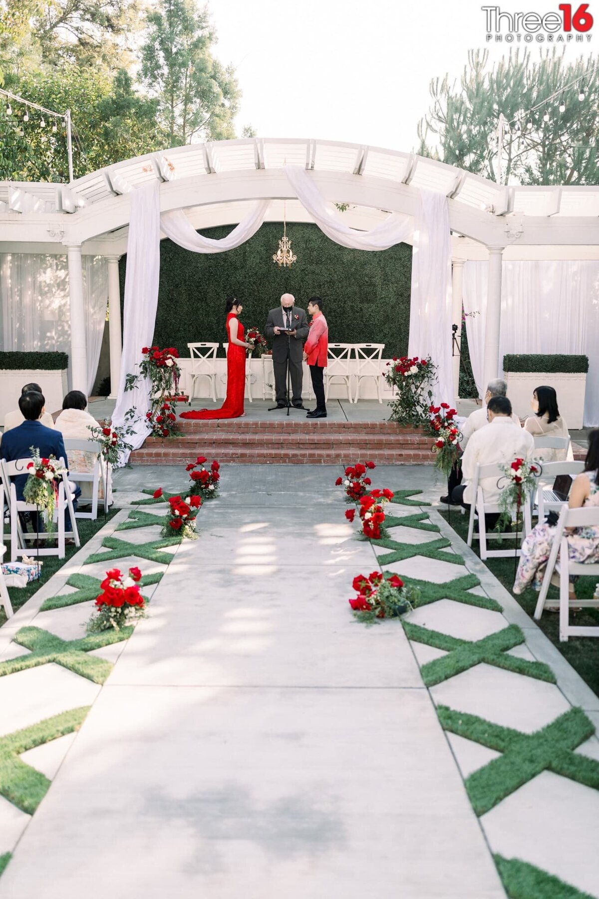 Chinese wedding taking place as Bride and Groom stand at the altar