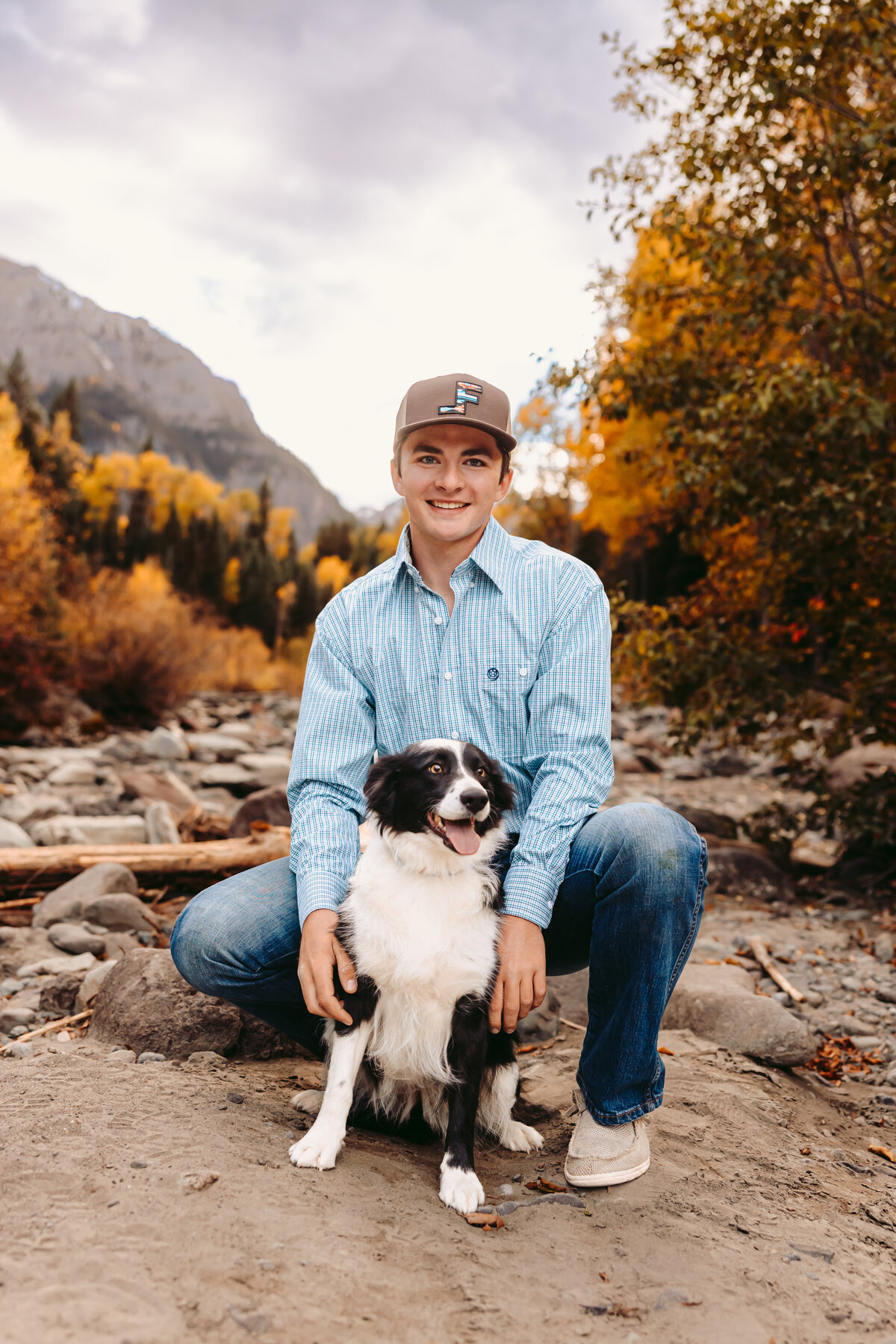 Josh poses with his dog for his Montrose senior pictures.