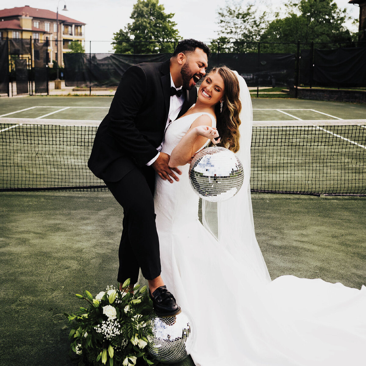 Bridge and groom on a tennis court with disco balls