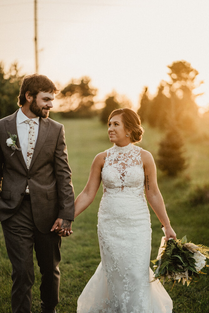 sunset-bride-groom-walking-iowa-wedding-storyteller-collective-photo-co
