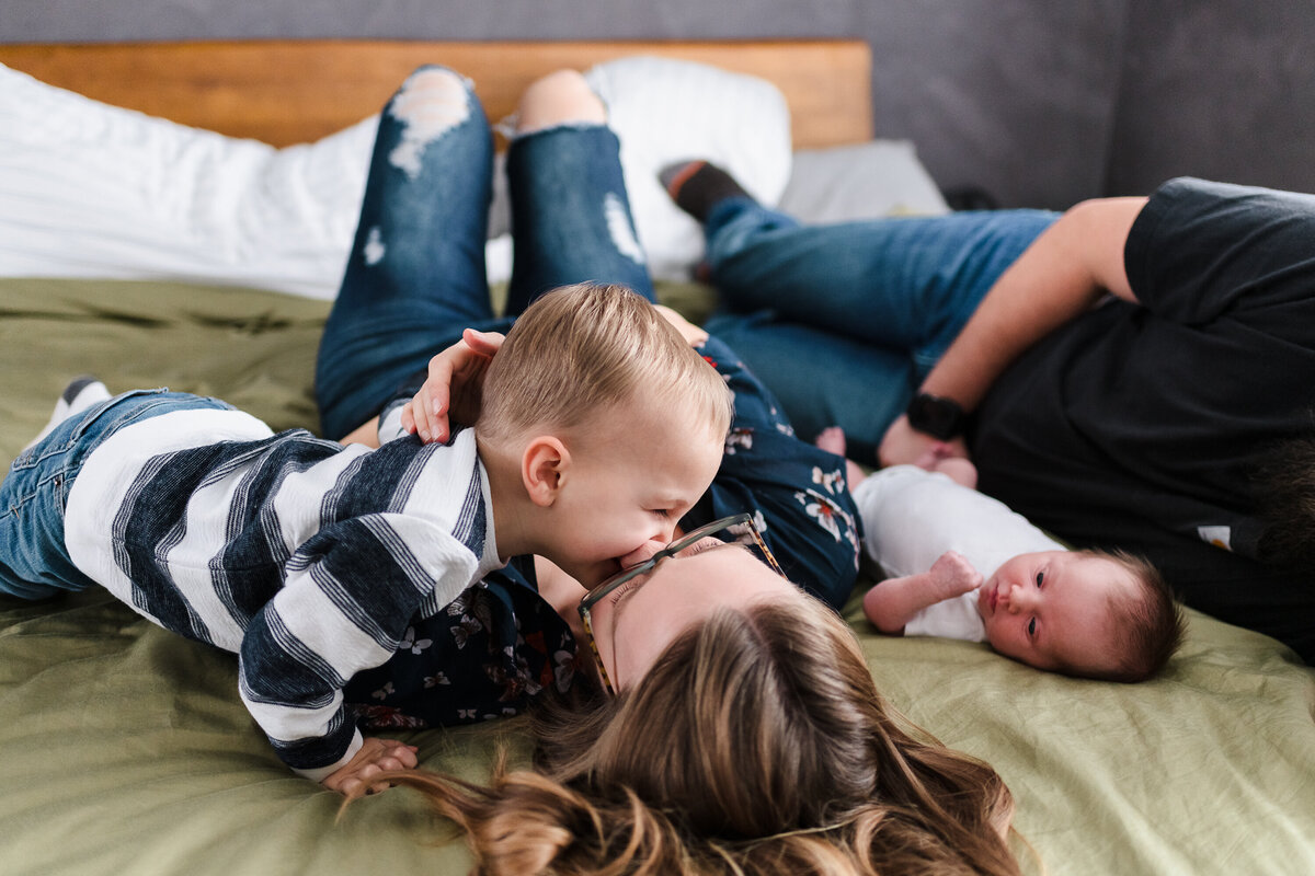 Family playful newborn photography session at home