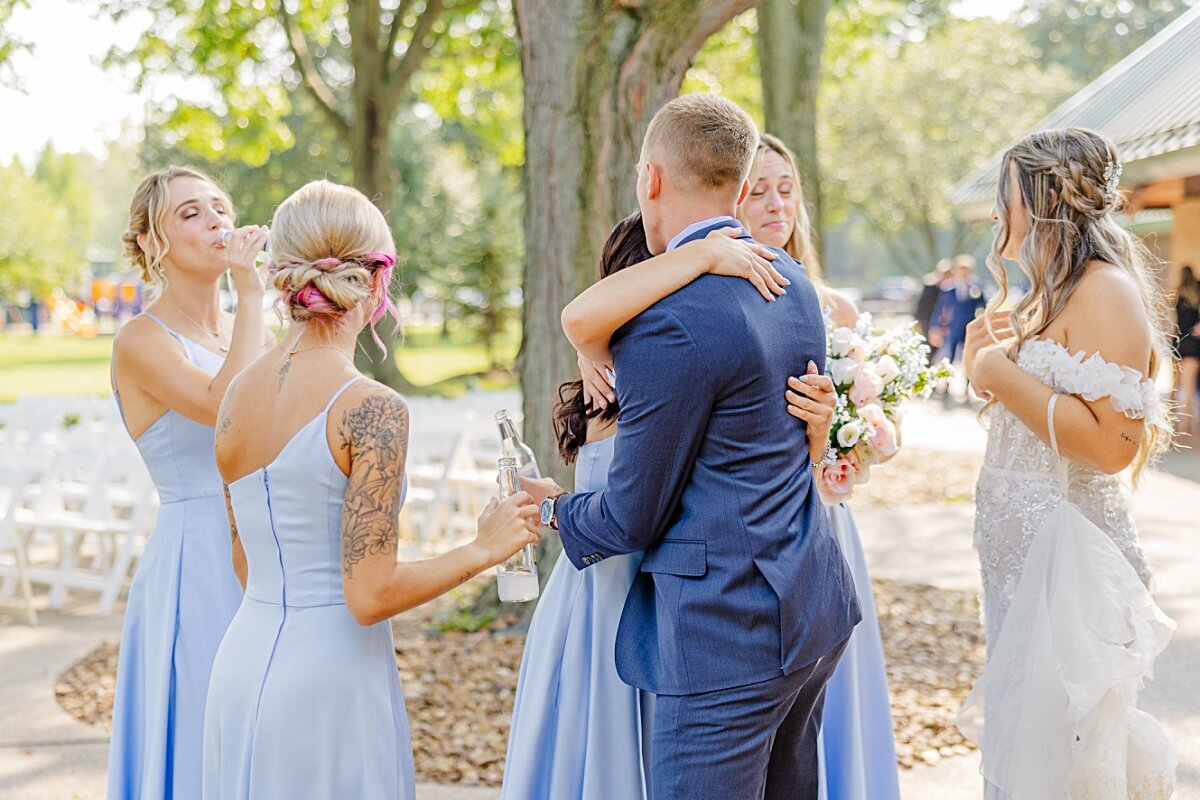 groom-hugging-bridesmaids-freedom-hill