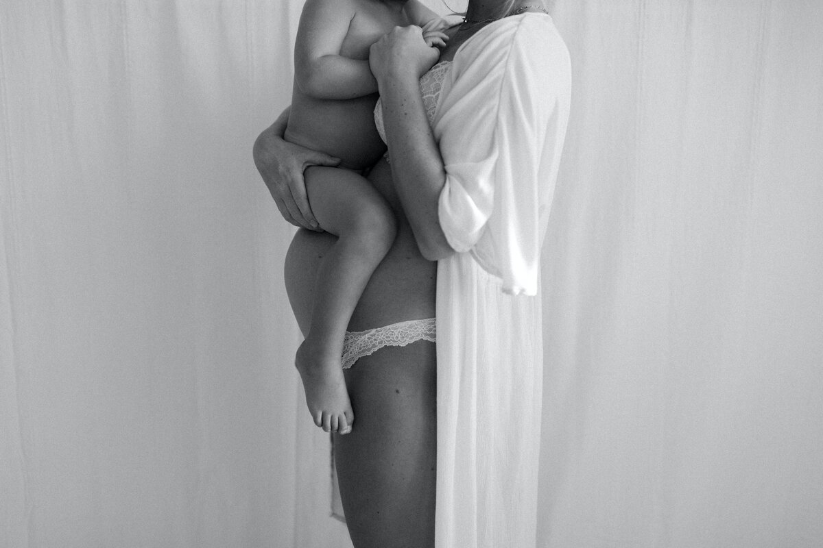 pregnant woman holding toddler