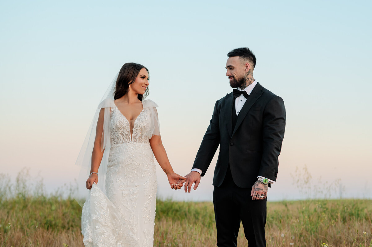 Bride and groom sharing a sweet embrace under the trees during their backyard wedding in Visalia