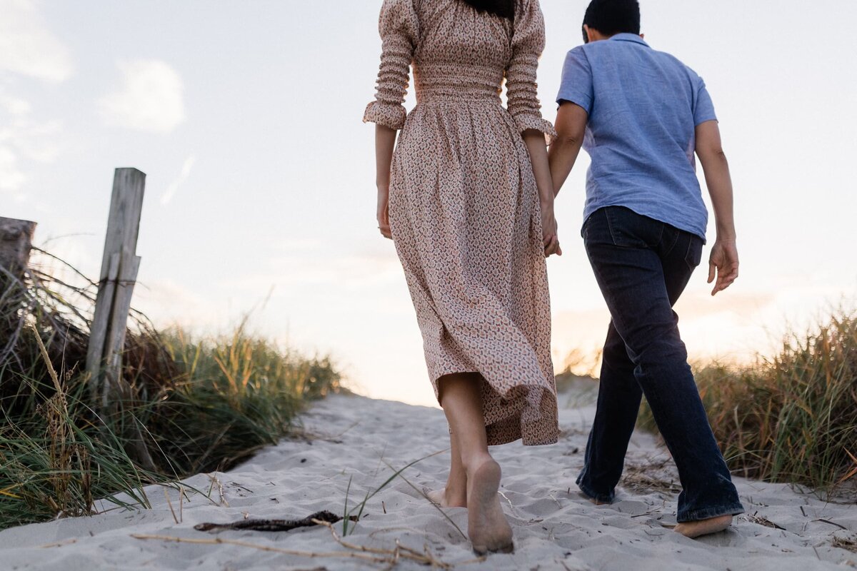 Lesbian couple walking on the beach at sunset in Ocean City NJ