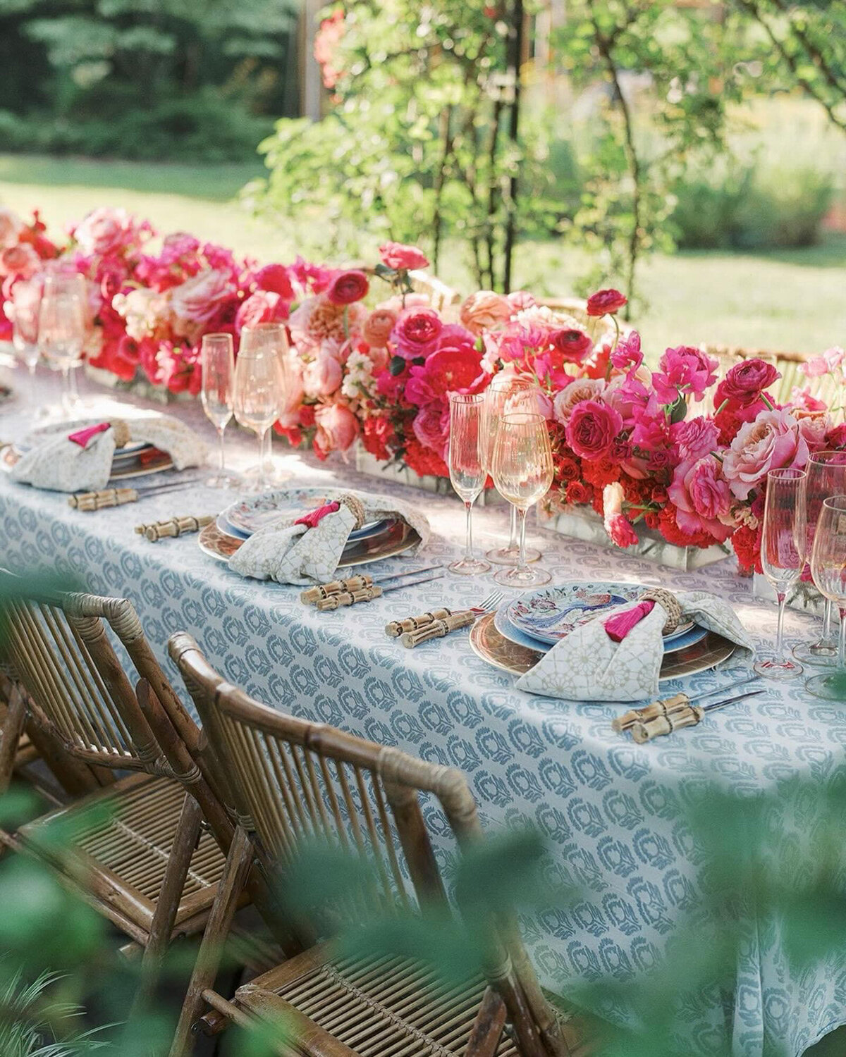 Colorful wedding reception table with pink floral centerpieces