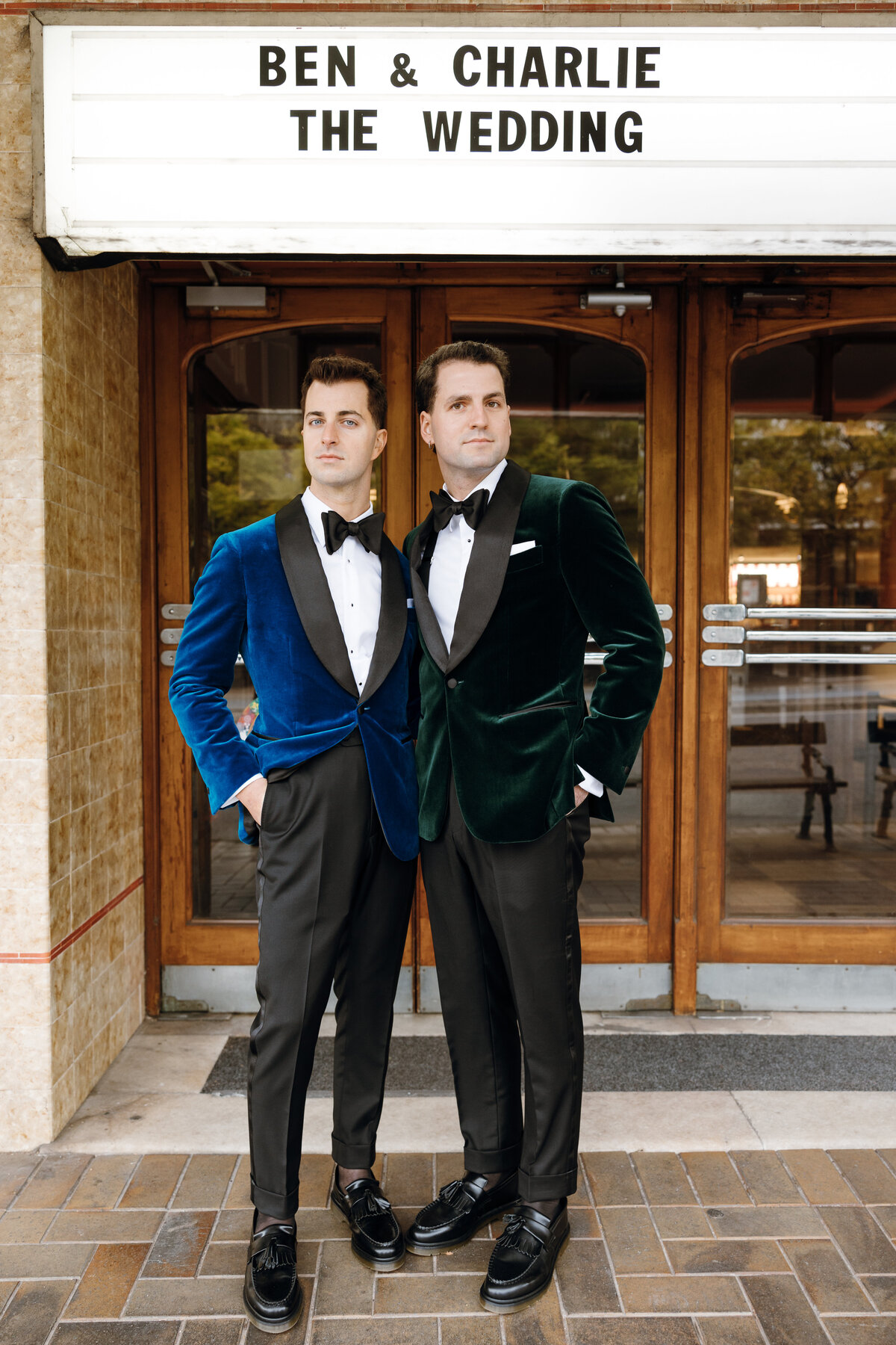 Text: Ben & Charlie The wedding. Two grooms outside their Regal Cinema wedding.