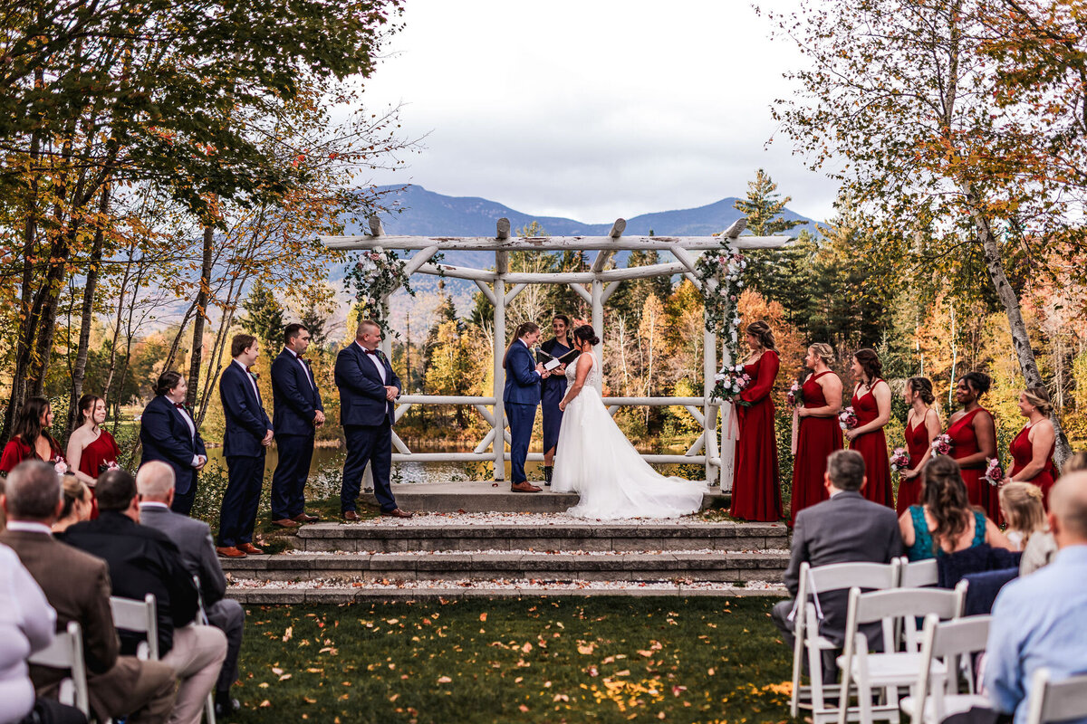 Gay couple exchange vows during ceremony at Waterville Valley Resort in NH by Lisa Smith Photography