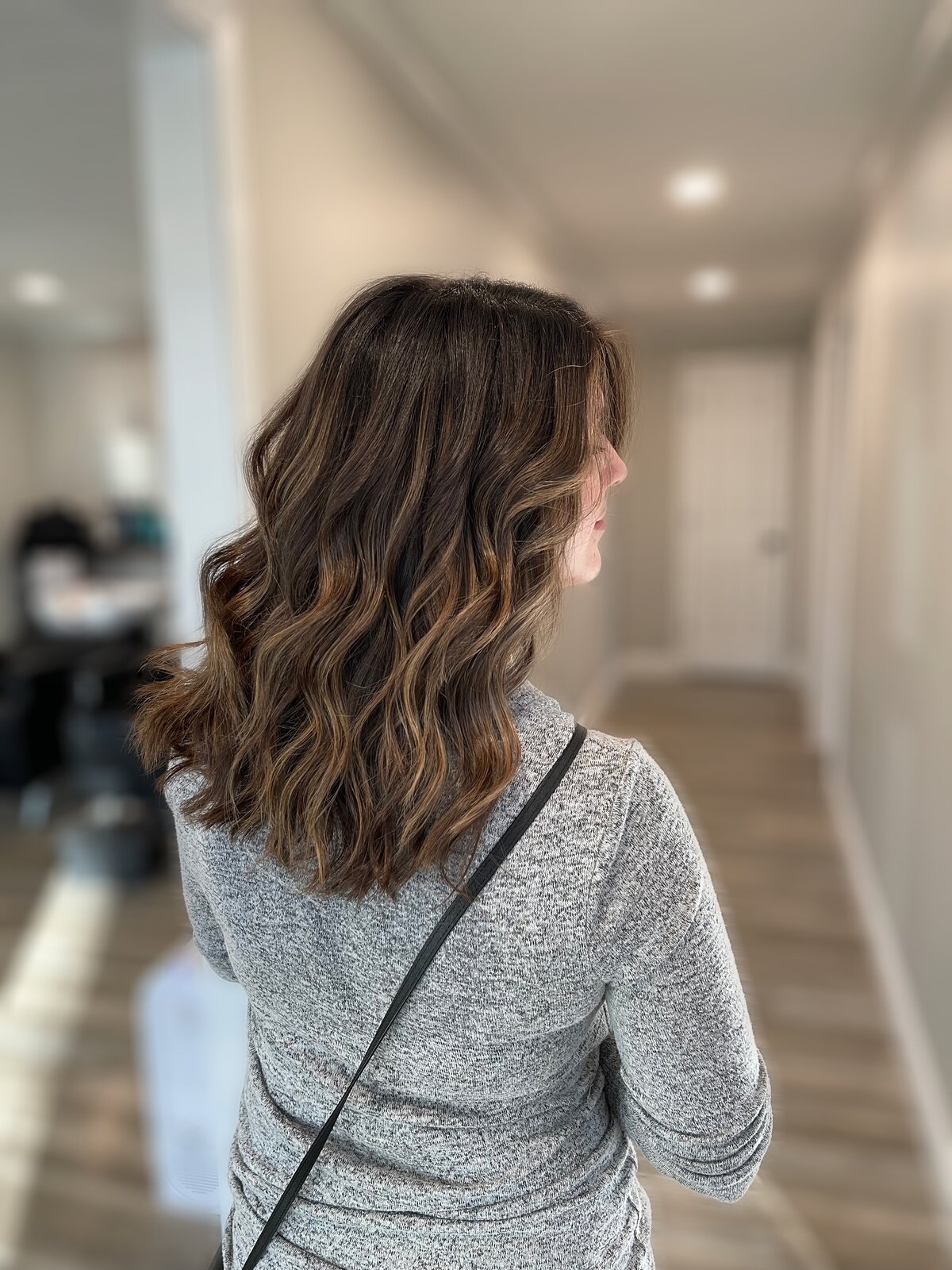 Subtle brunette balayage highlights on thick mid length hair