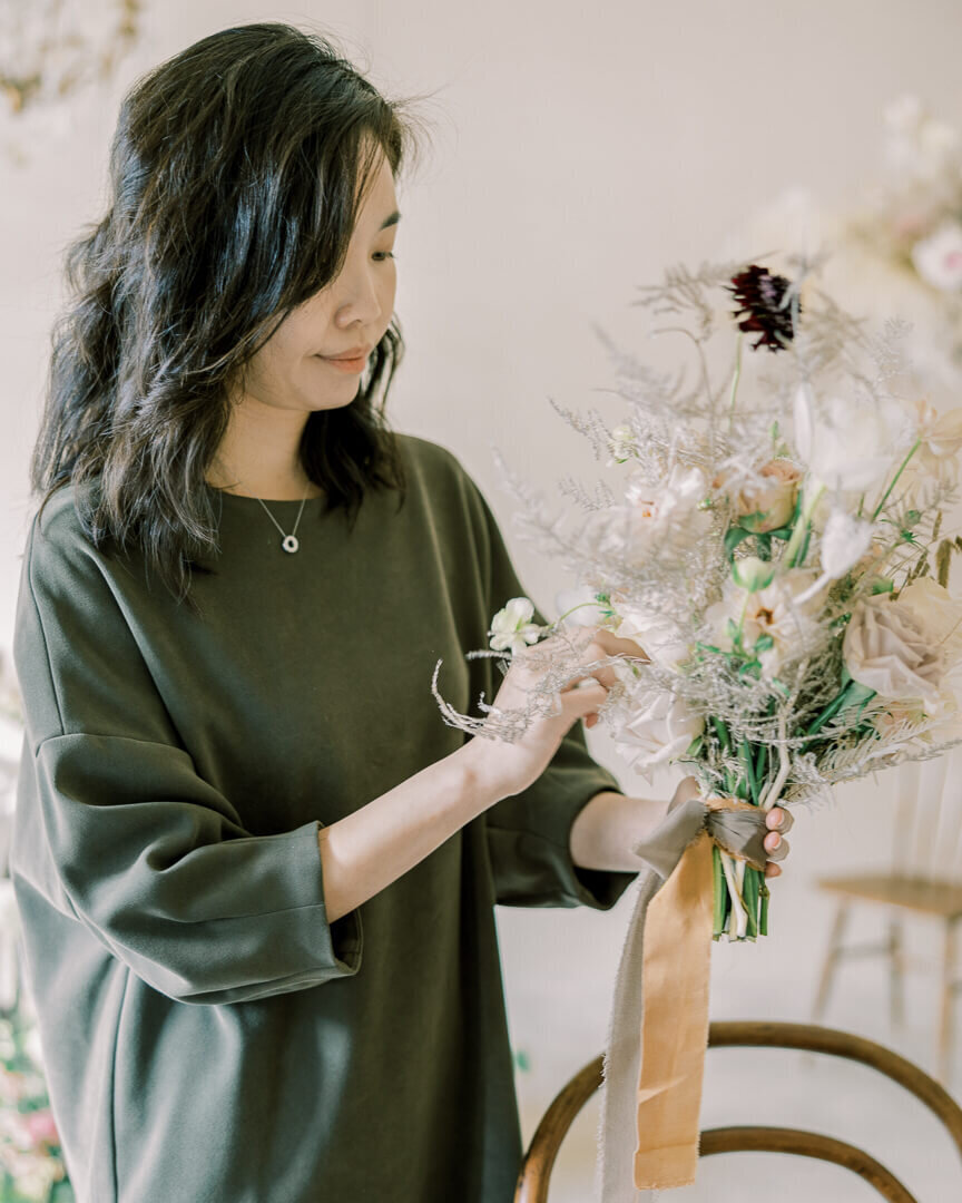 asian florist brand session arranging bridal bouquet