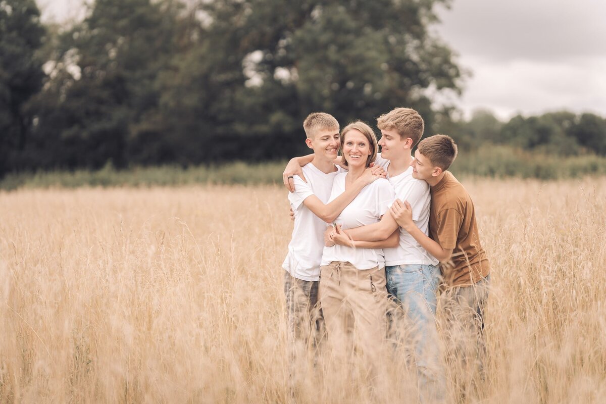 family standing in grass field