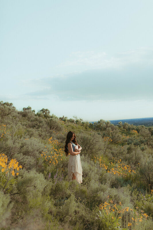 Standing in the distance, a woman poses for a photo taken by missionary photographer Brittney Ann Photography.