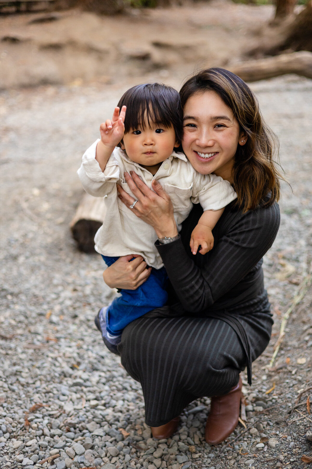 Mom holding toddler close and smiling at camera outdoors – Bay Area Family Portfolio | Ellobelle Photography