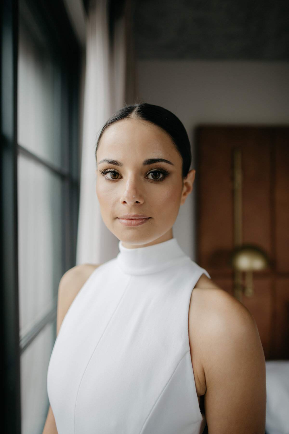 Headshot of Chicago bride standing by window