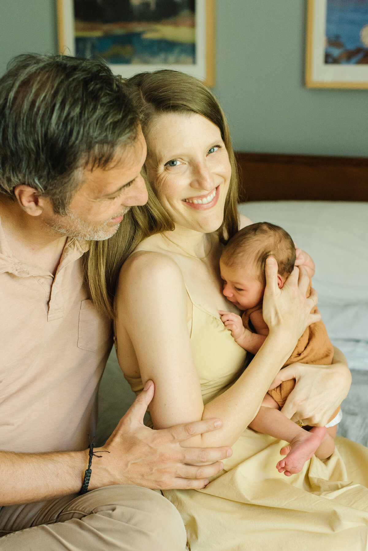Parents holding baby and smiling