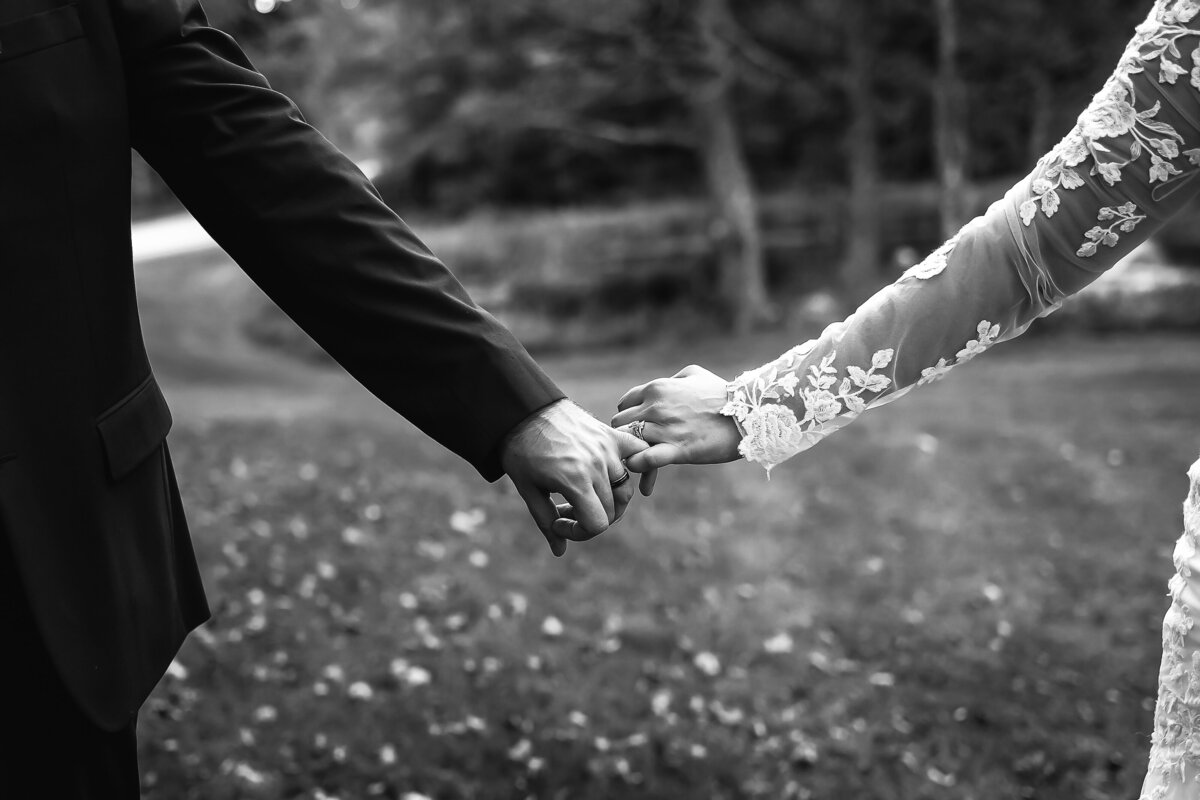 bride with long lace sleeves holding hands with groom by NH Wedding Photographer Lisa Smith Photography